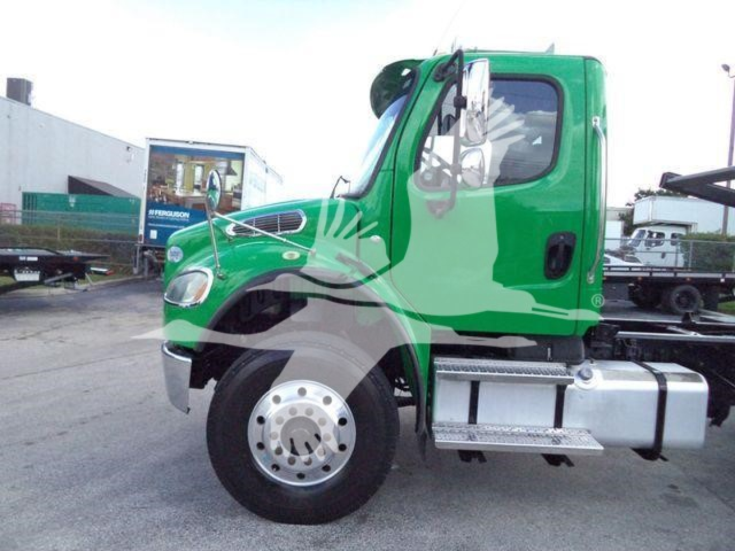 Truck cab side view showing green Freightliner M2-106 with chrome fuel tank and black windshield wipers.