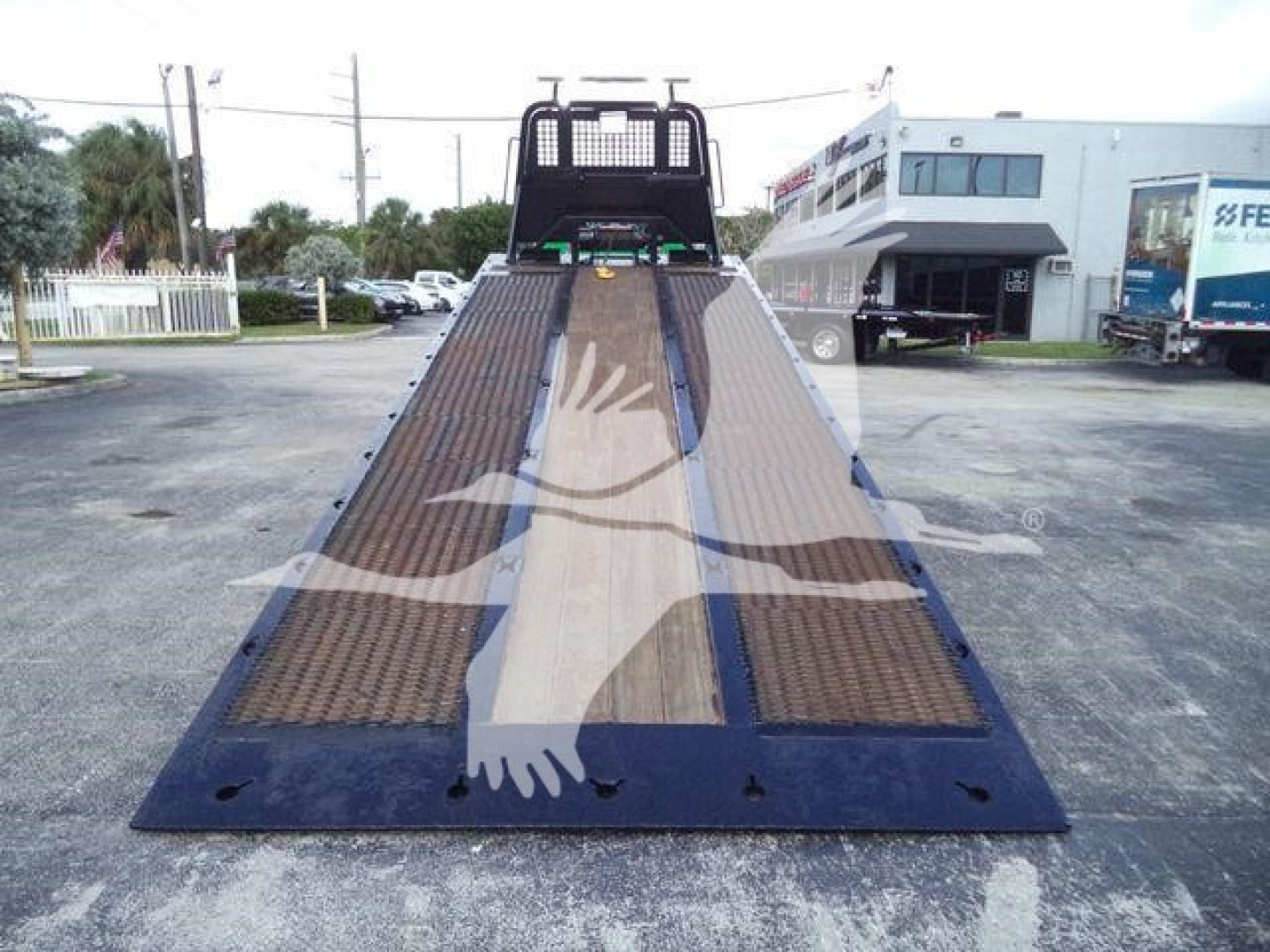 Flatbed rollback truck loading ramp with metal grating and blue frame; Freightliner M2 106 in listing context