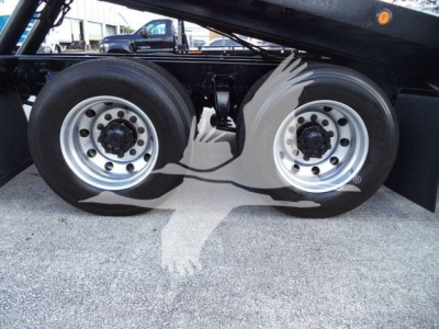 Freightliner M2 106 rollback chassis showing dual rear wheels and wheel hubs.