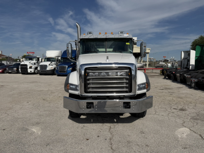 Mack GR64B truck front view showing chrome grille, bumper, and cab with amber clearance lights on top.