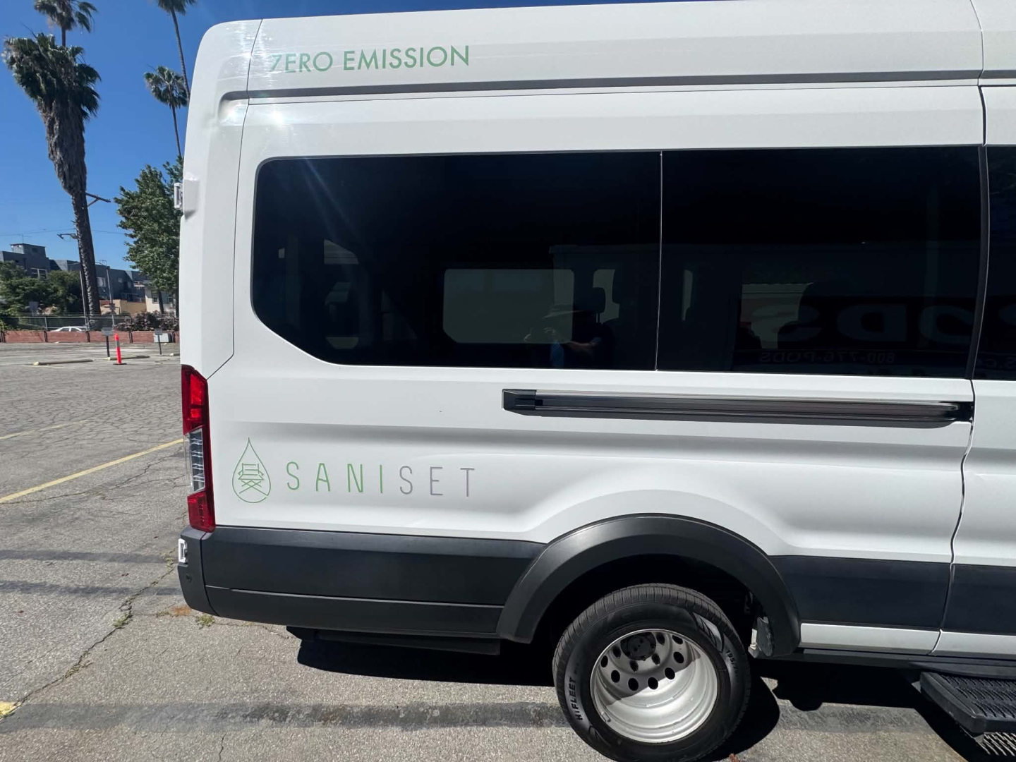 Ford Transit 350 HD van side view showing Saniset zero emission logo and VIN area on rear window.