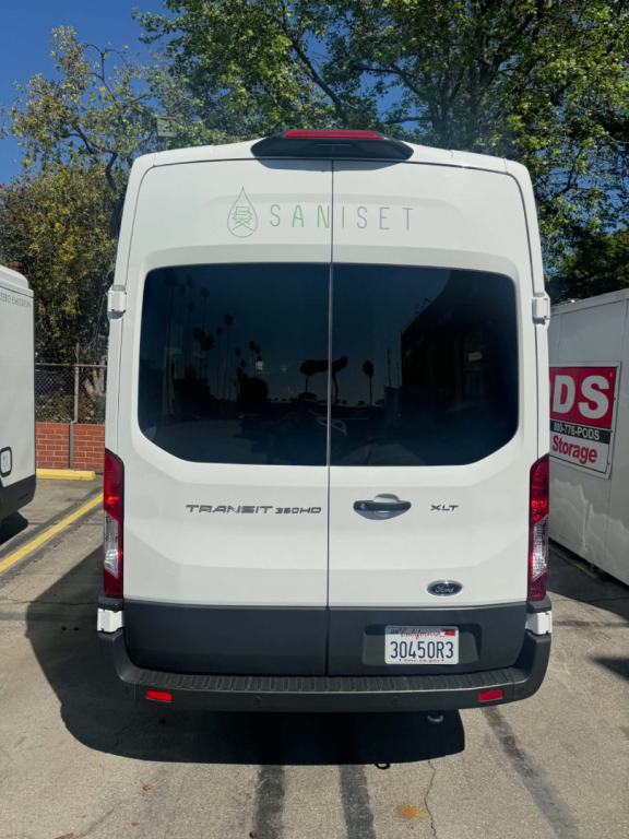 Ford Transit 350HD rear view with dual back doors. Visible text reads: SANISET decal across rear window, TRANSIT 350HD badge on left, XLT badge on right, Ford oval emblem, California-style license plate 30450R3.