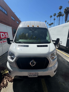 Front view of a white 2022 Ford Transit 350 HD van with black grille, hood scoops, and California license plate visible.