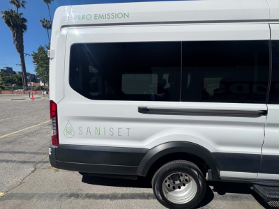 Ford Transit 350 HD van side view showing Saniset zero emission logo and VIN area on rear window.