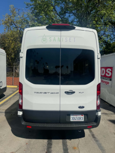 Ford Transit 350HD rear view with dual back doors. Visible text reads: SANISET decal across rear window, TRANSIT 350HD badge on left, XLT badge on right, Ford oval emblem, California-style license plate 30450R3.