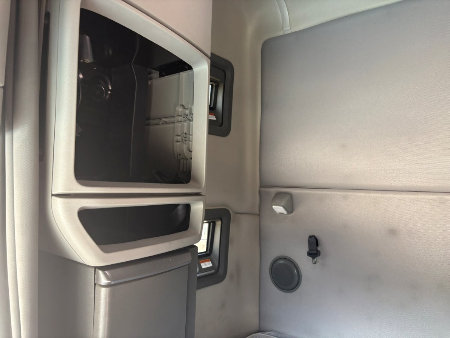 Volvo VNL64T760 dash area and open storage compartment visible inside cab.