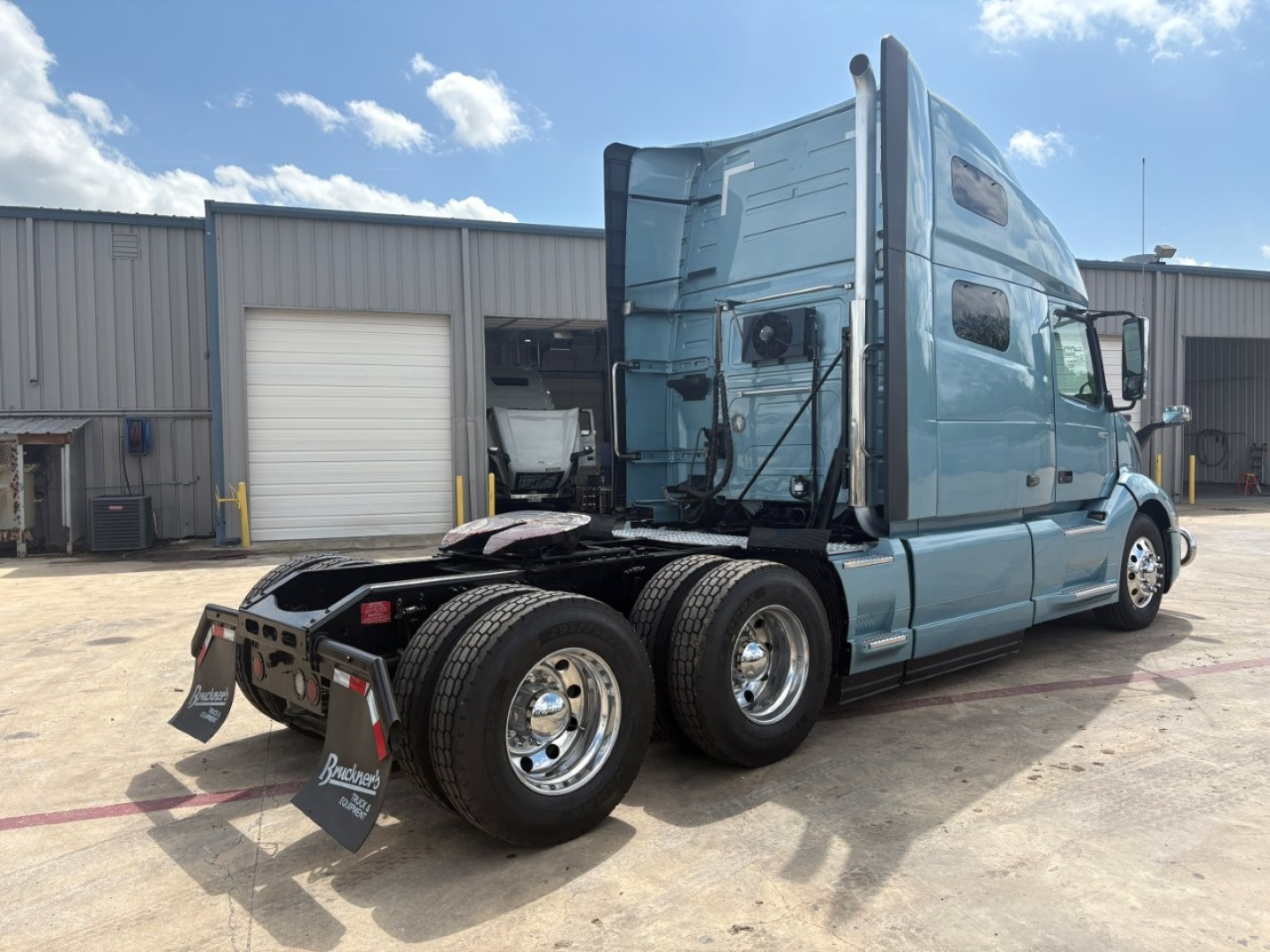 Volvo VNL64T760 tractor rear quarter view showing dual rear axle and sleeper cab.