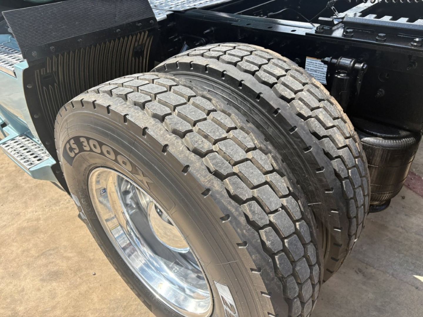Volvo VNL64T760 sleeper cab rear dual rear tires showing Goodyear tires and chrome wheel rims.