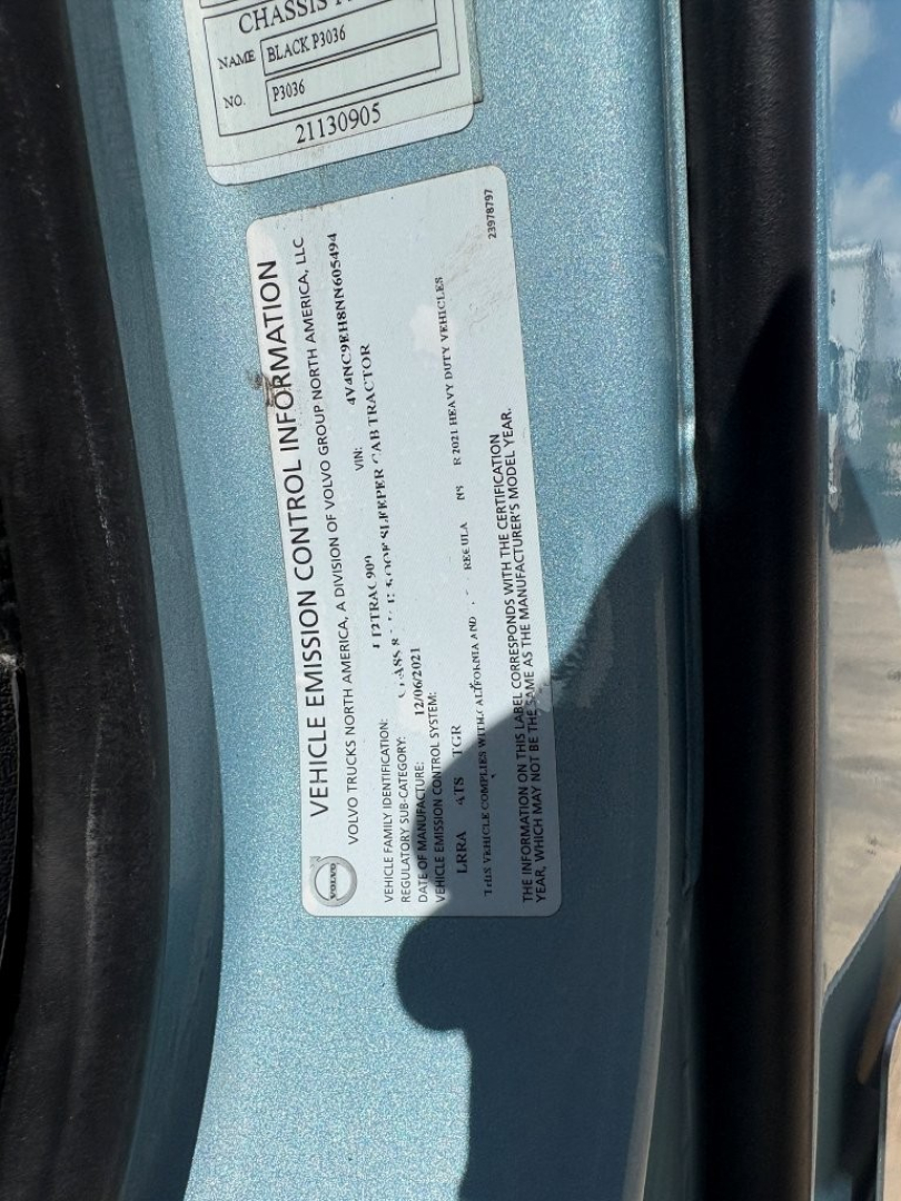 Vehicle information label on Volvo VNL64T760 side showing emission information and VIN area.