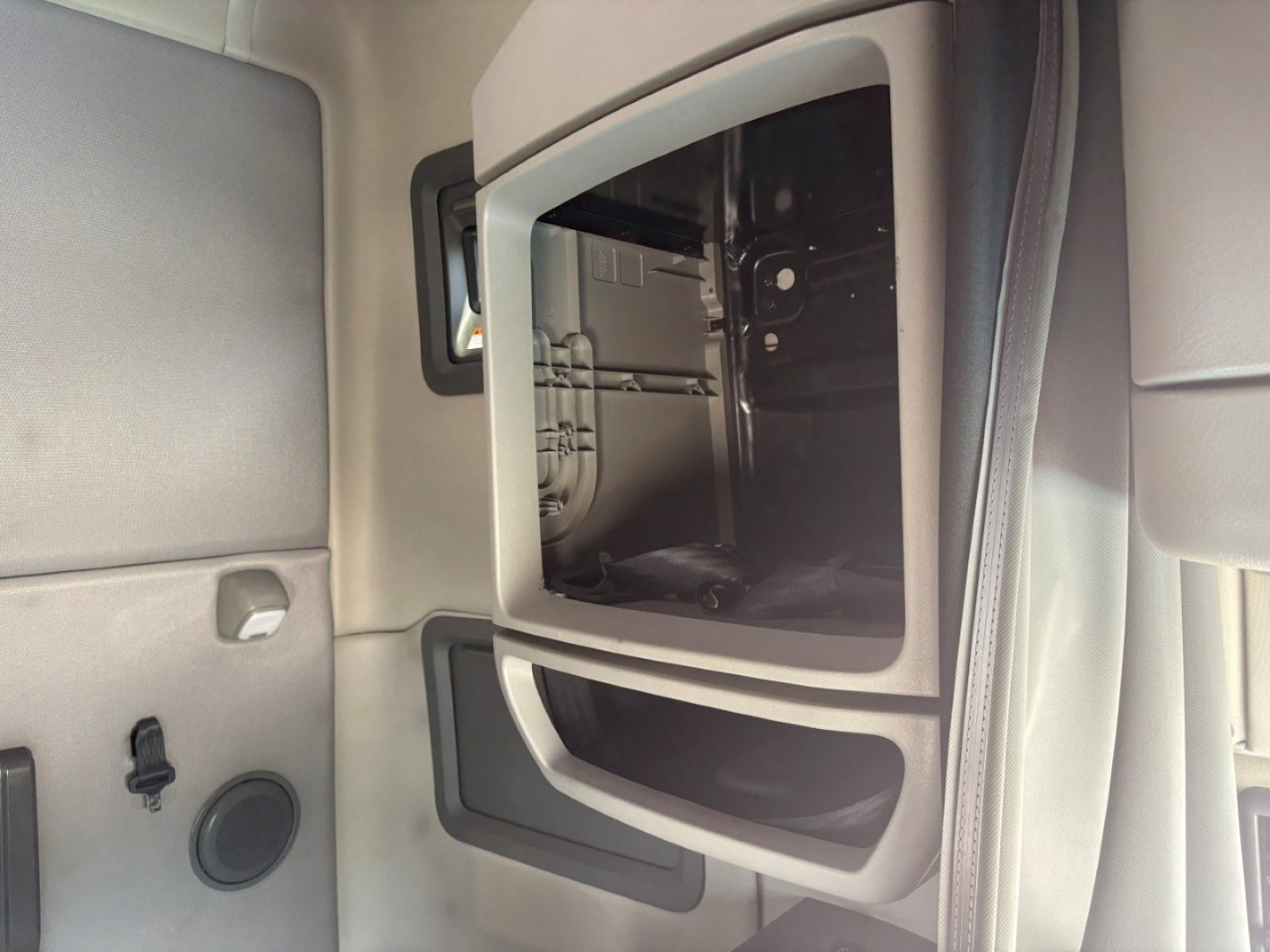 Volvo VNL64T760 sleeper cab interior showing open overhead storage area and dash side panel.