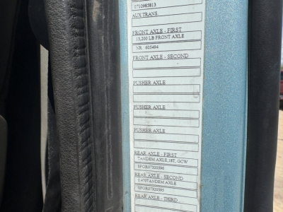 Label plate on Volvo VNL64T760 cab showing axle ratings and serial numbers including 'Front Axle - First 13,200 LB Front Axle' and various 'Pusher Axle' and 'Rear Axle' entries visible on the door jamb.