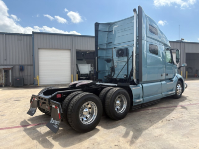 Volvo VNL64T760 tractor rear quarter view showing dual rear axle and sleeper cab.