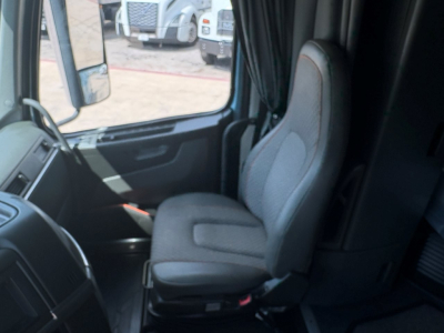 Vehicle interior cab seating of a Volvo VNL64T760 truck showing front passenger seat and dashboard area.