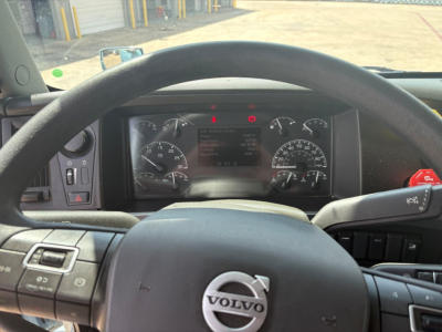 Volvo VNL64T760 interior dashboard view with steering wheel and instrument cluster visible.