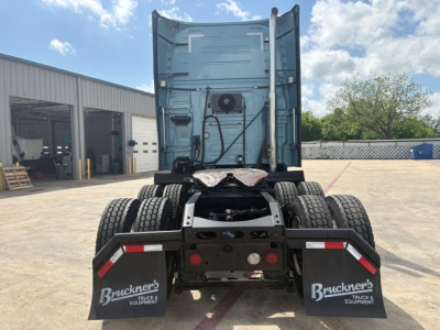 Rear view of a Volvo VNL truck tractor showing the back of the cab and sixth-wheel area with dual rear axles and mud flaps labeled 'Bruckner's Truck & Equipment'