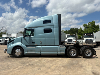 Volvo VNL64T760 tractor in side profile showing sleeper cab and rear axles.