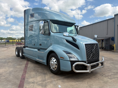 Truck image: 2022 Volvo VNL64T760 conventional sleeper tractor, light blue, front bull guard, chrome wheels, dual rear axles, side mirrors, aerodynamic hood