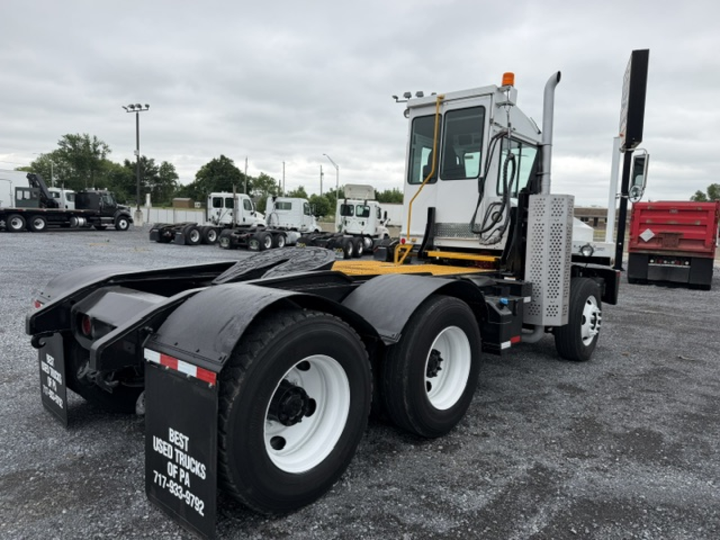 Capacity TJ6500 truck tractor shown from side with rear dual axles and white wheels.