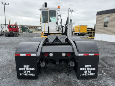 Tractor-style yard truck with TJ6500 tag showing rear view, twin fenders and hitch assembly.