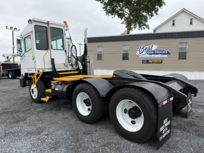 Tractor unit chassis showing rear dual-axle configuration and white cab with yellow frame accents.