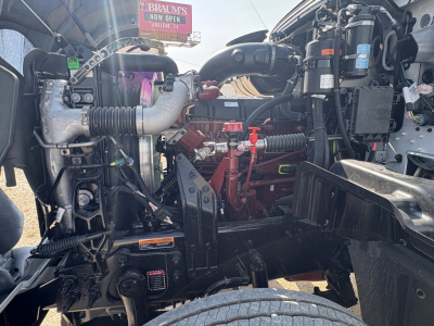 Mack GR64FT engine bay showing air intake, turbocharger, hoses, and various engine components.