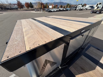 Alpha A80MG lowboy trailer deck with wooden planks and swing-out side, metal frame, flatbed view from rear corner.