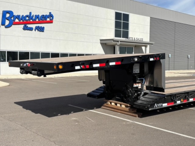 Trailer showing lowboy chassis with swingouts and detachable double drop deck at Bruckner's facility