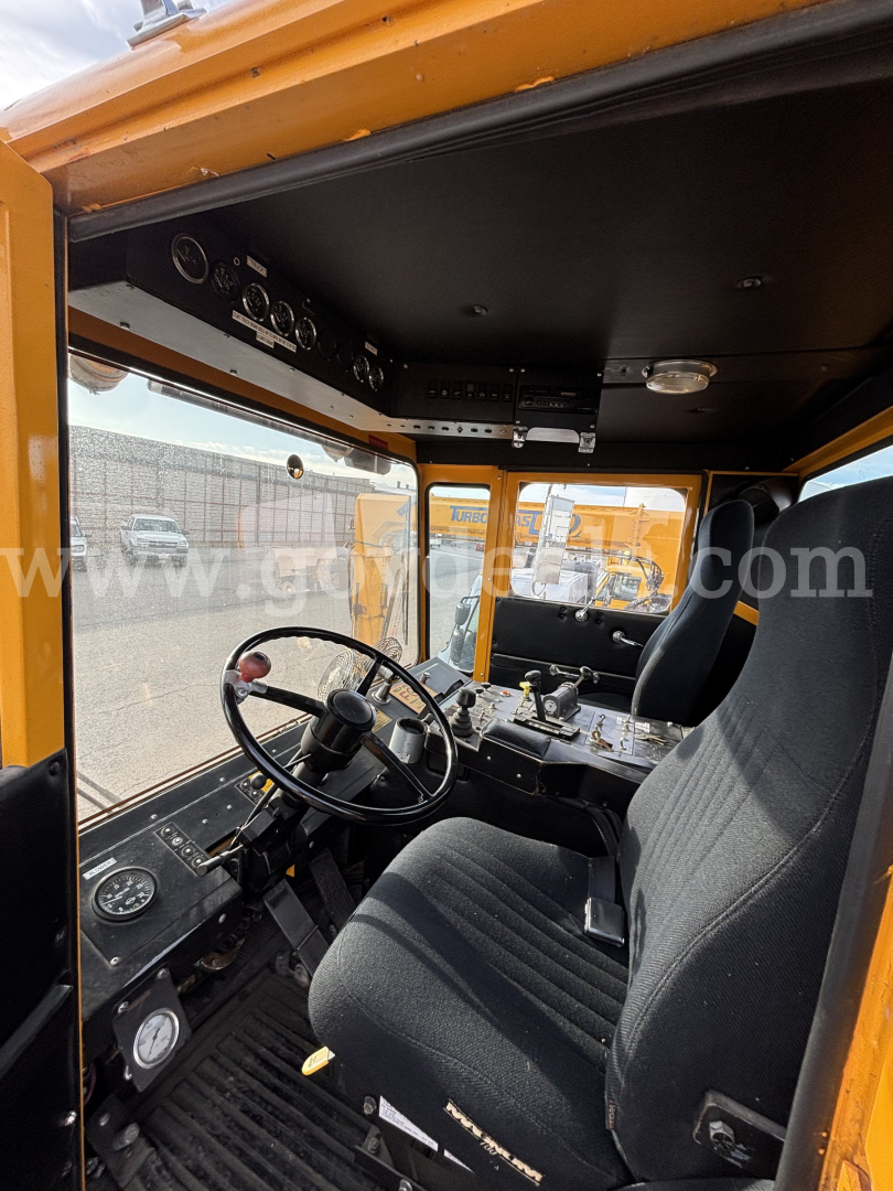 Cab interior of a Kodiak truck showing steering wheel, dashboard gauges, and driver seat.