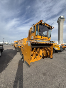 Kodiak CD6072-119 snow blower with large auger housing and operator cab in yellow, equipped for winter road work.