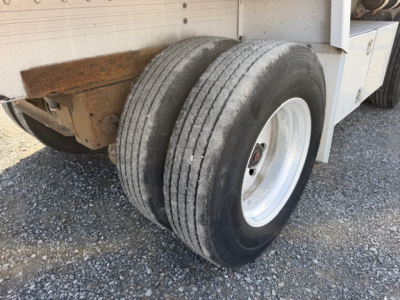 MaxMiser trailer wheel area showing dual rear tires and white rim