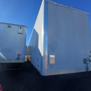 Trailer rear view of a 2014 Wabash air ride dry van with riveted aluminum doors and side marker lights.