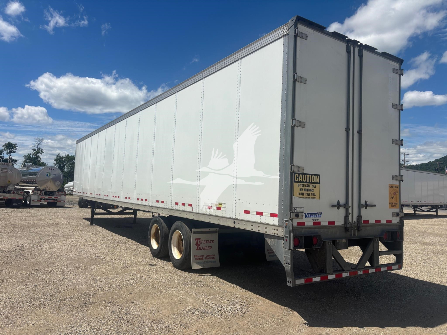 Vanguard VXP trailer showing side view and rear doors with CAUTION sign and reflective tape.