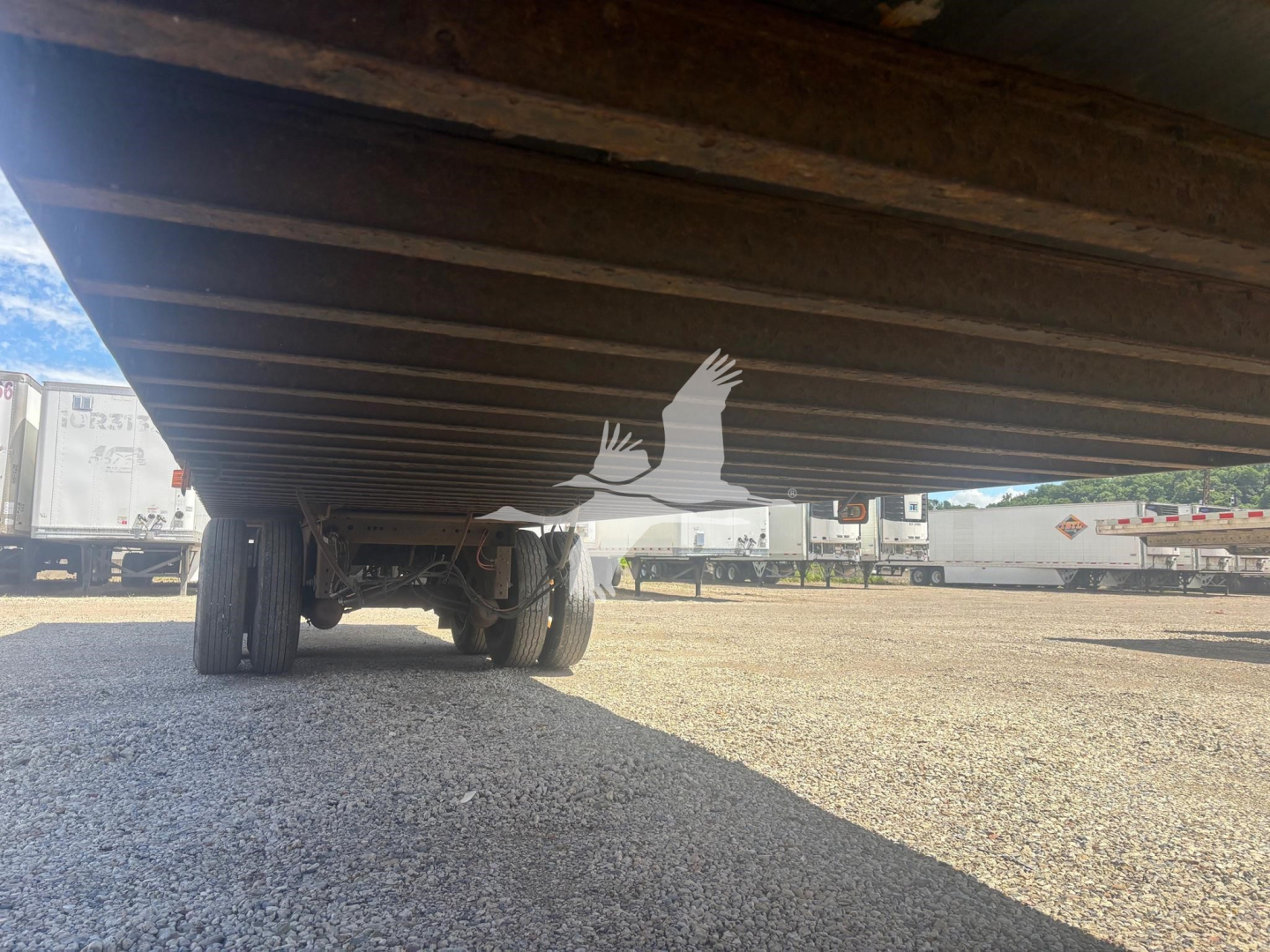 Underside view of a Vanguard VXP trailer showing the undercarriage and dual rear wheels.