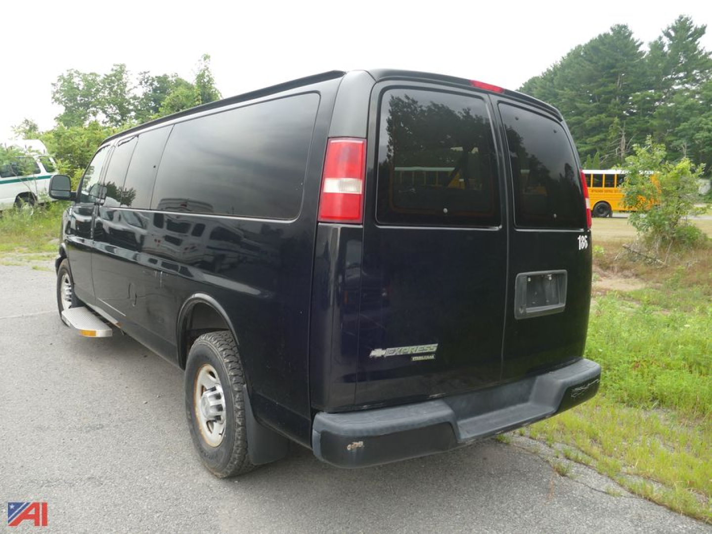 Rear-right view of a dark blue 2013 Chevrolet Express LS 3500 extended van showing taillights, rear doors, and bumper.