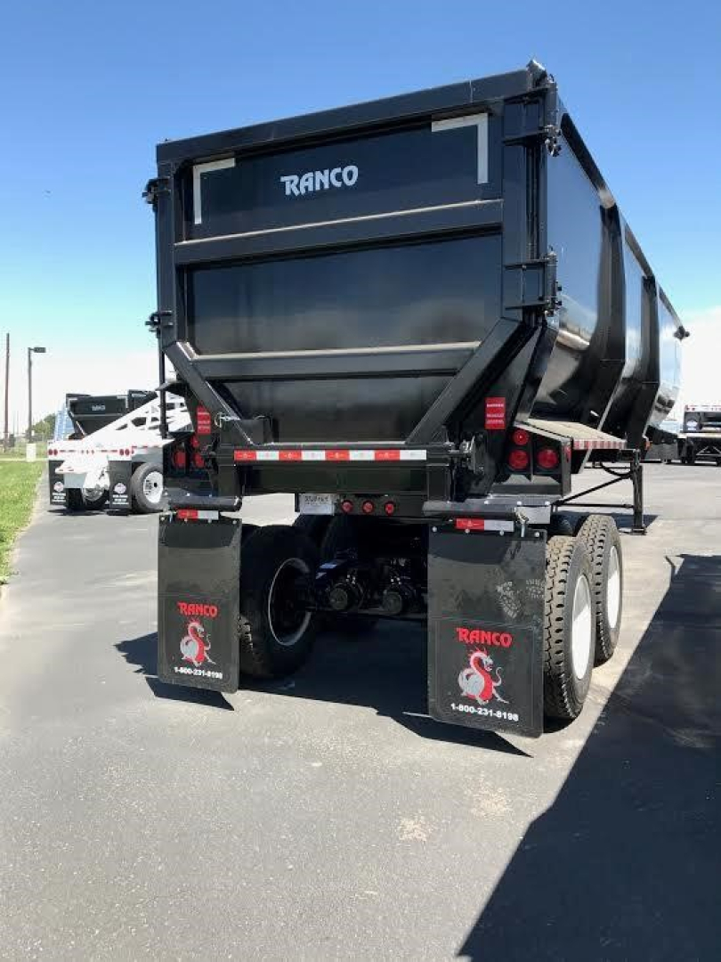 Ranco Ed60-38 dump trailer rear view showing dual rear axles, black dump body, RANCO branding on tailgate and mud flaps.