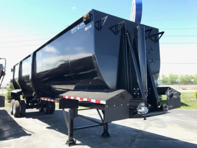Ranco Ed60-38 dump trailer showing black steel cargo body and raised hitch with support legs and frame.