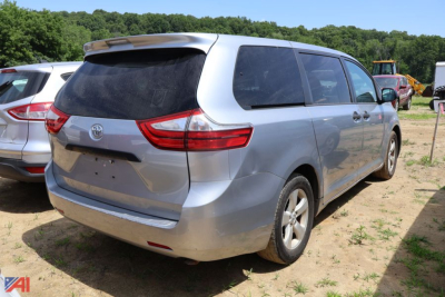 Toyota Sienna minivan rear view showing tail lights and rear hatch in a lot.