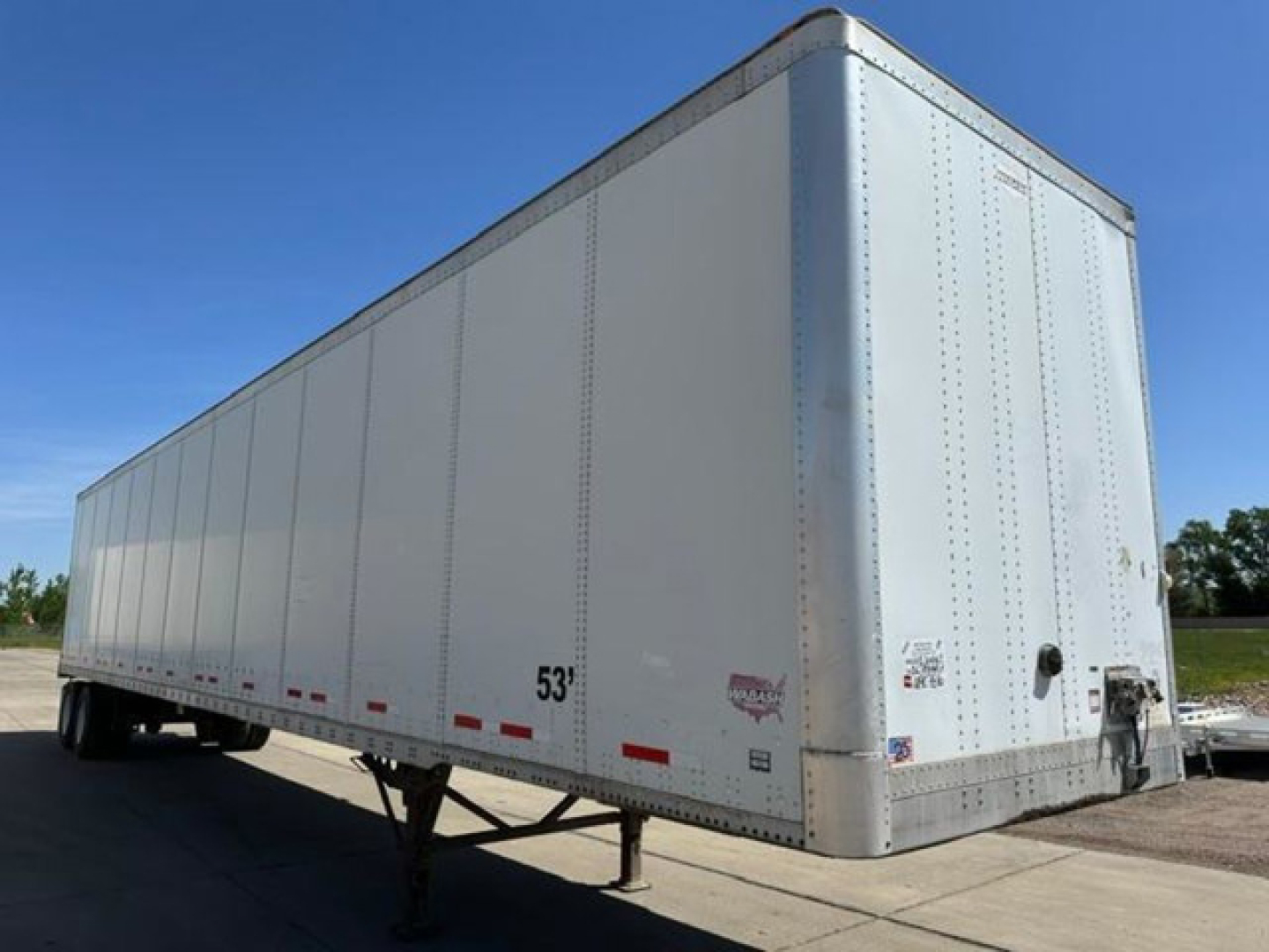 Trailer van showing 53' box with front and side panels and rear doors, aluminum exterior, no visible branding text.
