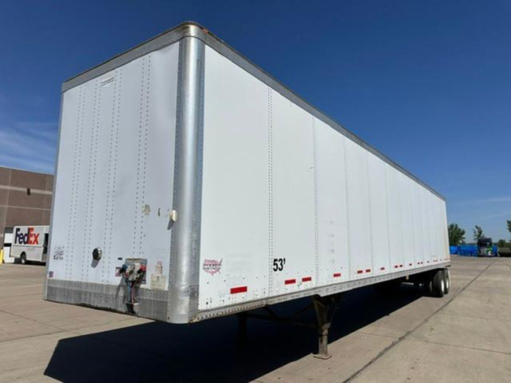 2013 Wabash van trailer showing white aluminum box body with front corner, side text and rear double doors, 53’ length marking on side, dual rear hubs.