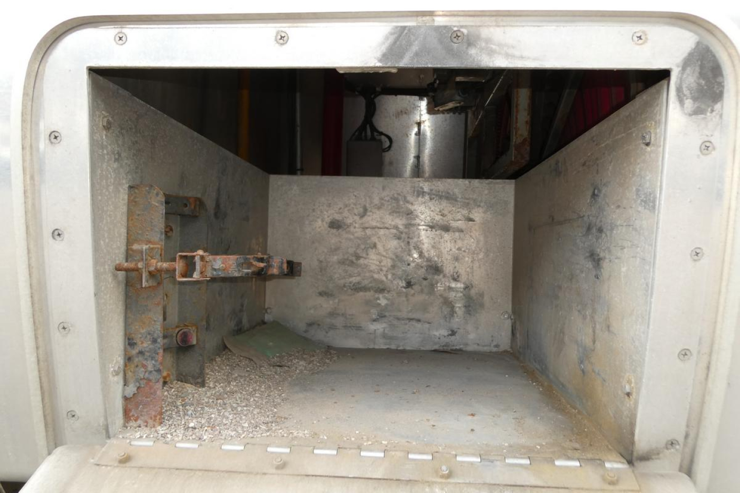 Sterling L7500 truck cab interior cargo area with metal walls and latch mechanism visible.