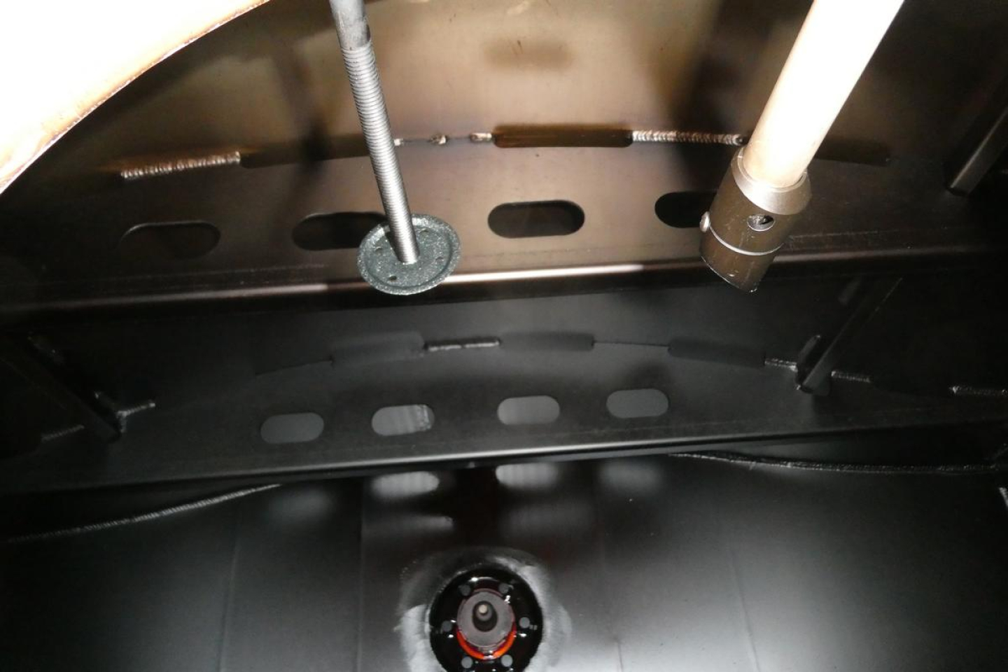 Trucks engine bay view showing fuel system components and wiring on Sterling L7500. Visible lines, fittings, and circular hatch area.