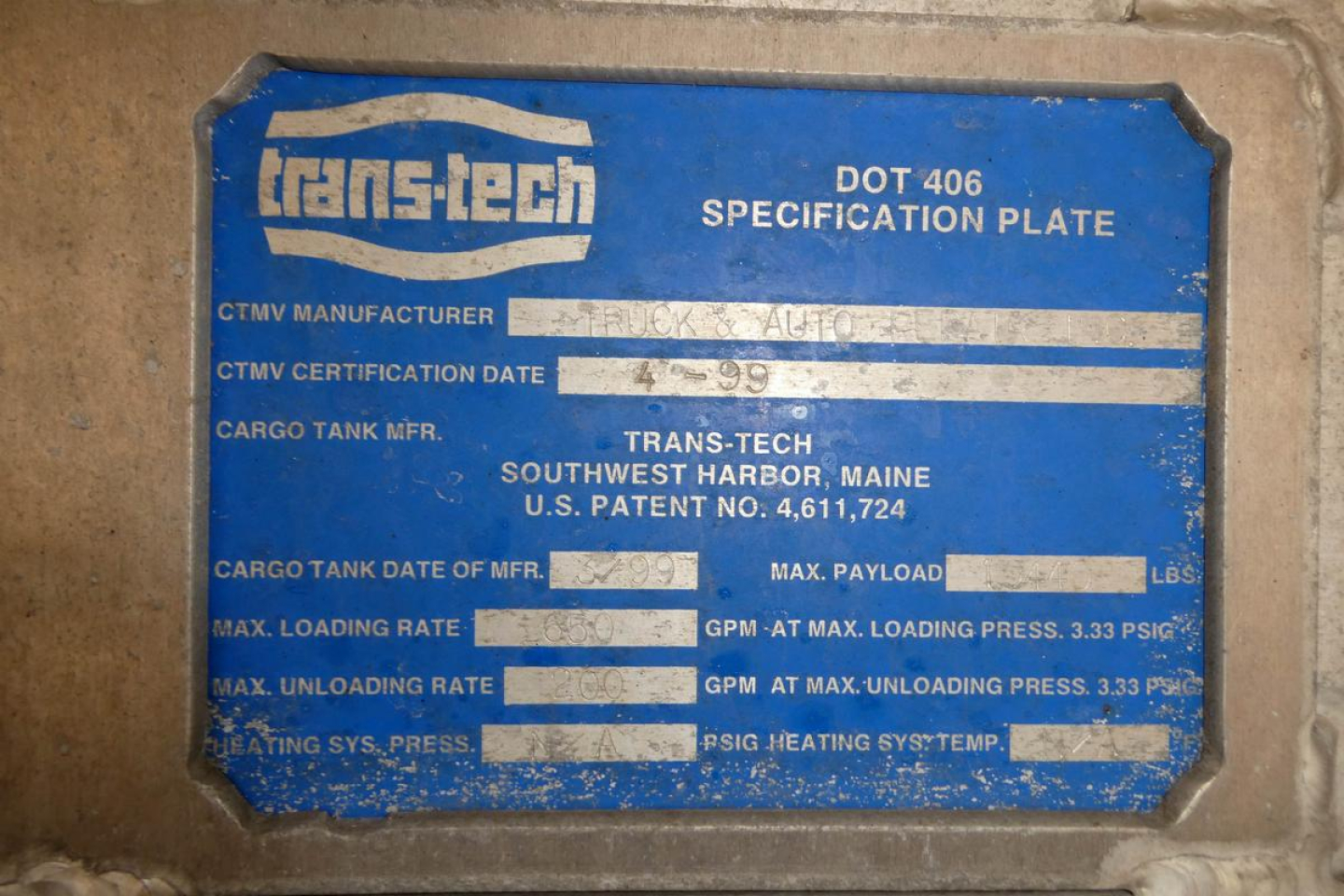 Trans-tech dot 406 specification plate on truck showing CTMV manufacturer, date 4-99, cargo tank, max payload, max loading rate, max unloading rate, various PSI ratings.