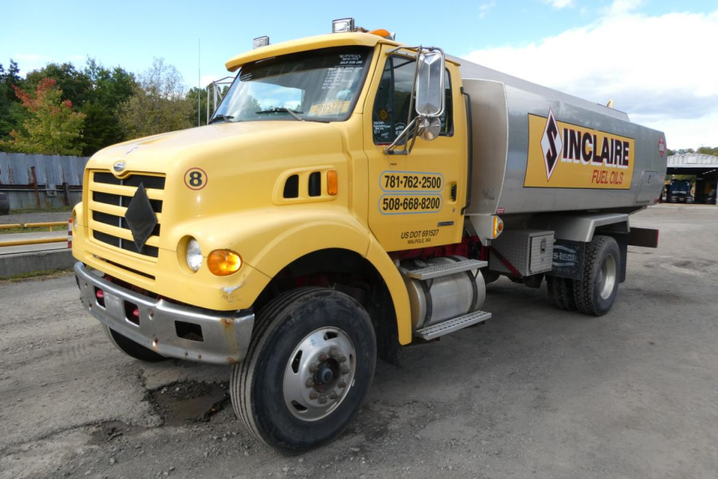 Large yellow Sterling L7500 gasoline truck with tank trailer, Inclaire logo on tank, front view showing wheel, cab, and side crew numbers.