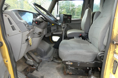 Cab interior of a Sterling L7500 truck showing steering wheel, dashboard, and two front seats.