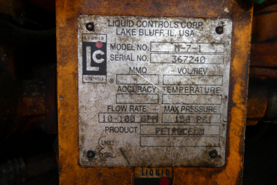 Plate on equipment with model, serial, and specs from Liquid Controls Corp. showing model no. M?7-? and serial no. 367240, max pressure 1500 psi, flow rate 0-100 GPM, product PETROLEUM, location Lake Bluff IL USA.