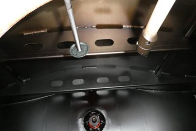 Trucks engine bay view showing fuel system components and wiring on Sterling L7500. Visible lines, fittings, and circular hatch area.