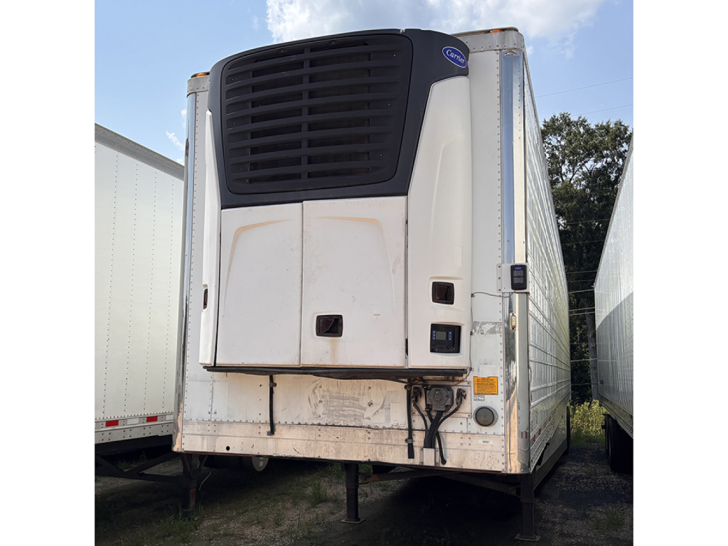 Trailer rear showing Carrier or similar refrigeration unit on a 2013 Utility 3000R reefer trailer with white sides and black cooling unit grille.