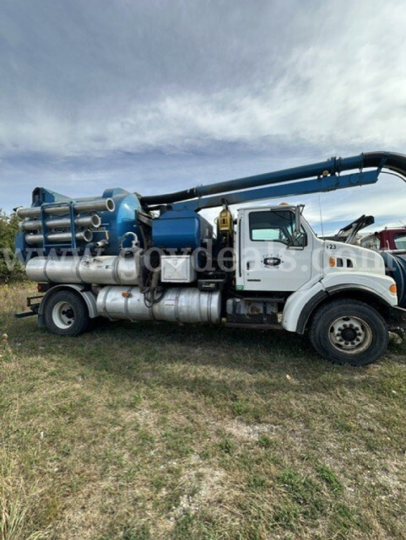 Sterling L7501 vacuum truck side view showing large blue vacuum tank and pump assembly mounted on a white truck chassis