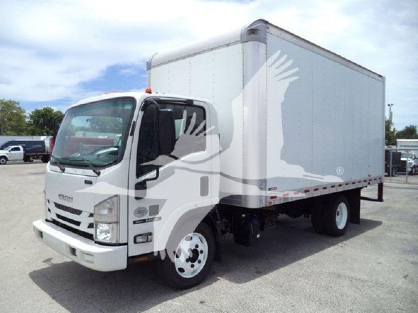 Isuzu NPR/NRR box truck showing cab and a large box cargo area with stock number plate and VIN tag visible.
