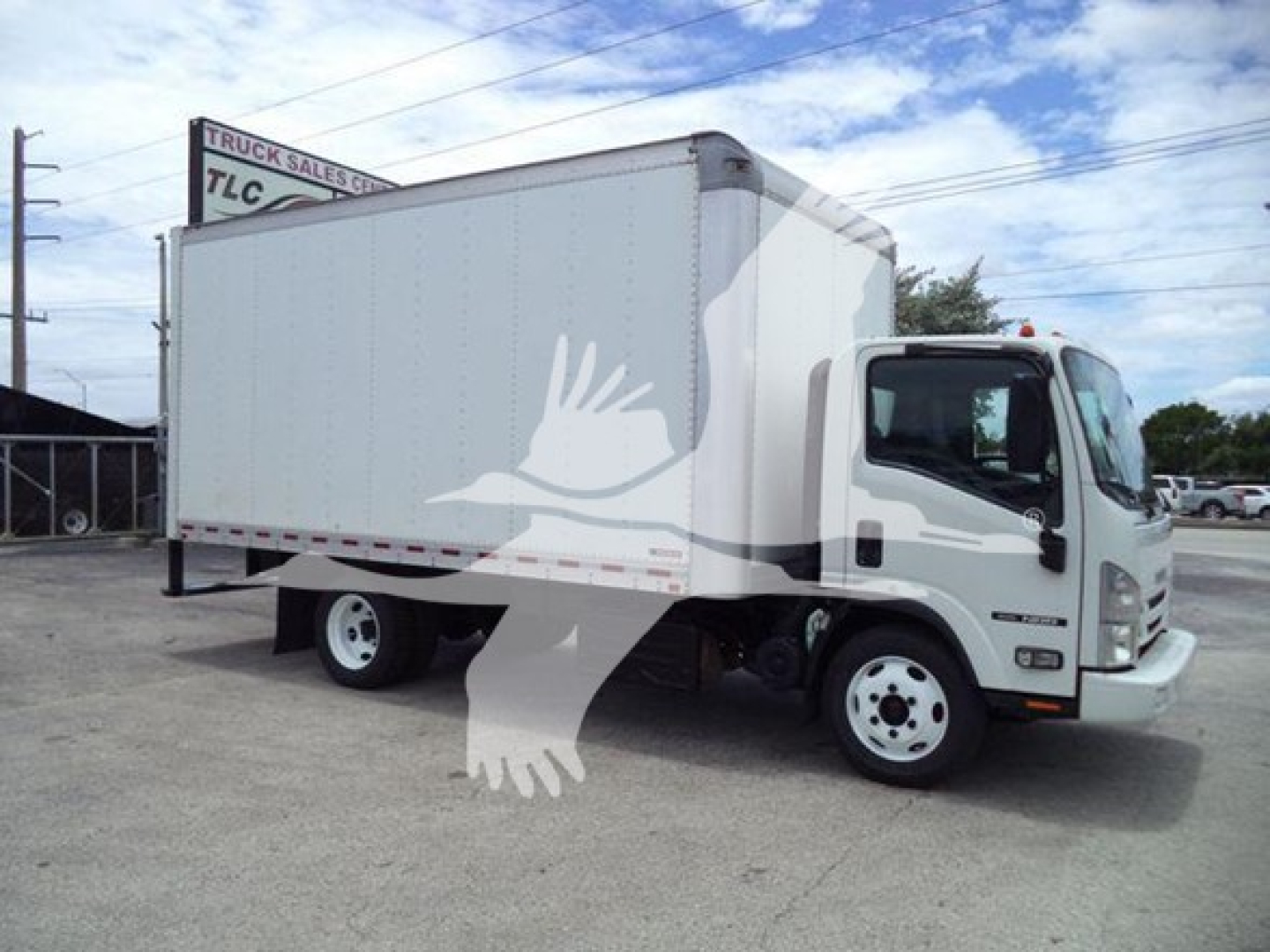 Isuzu box truck with cargo box, front cab visible. Tags show VIN and stock; side of truck blank.